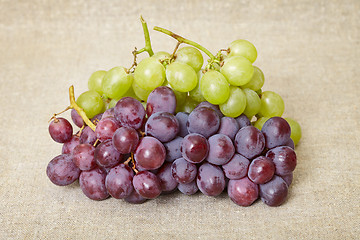 Image showing Red and green grapes on canvas background