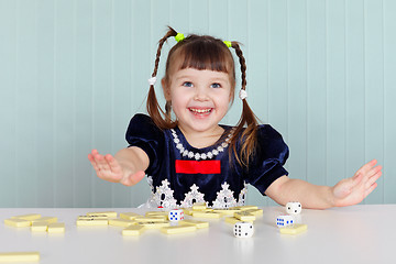 Image showing Happy beautiful child plays with toys on table