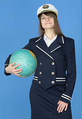 Image showing Girl in sea uniform with globe