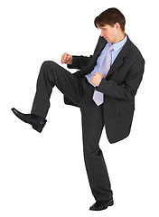Image showing Businessman kicks down on white background