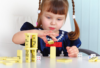 Image showing Child playing with dominoes