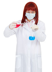 Image showing Woman scientist mixes colored chemical solutions