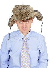 Image showing Portrait of young man in fur hat isolated on white background