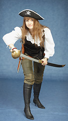 Image showing Young woman in clothes of pirate on blue background