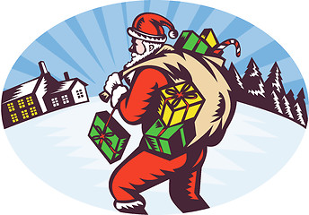 Image showing santa claus bringing bag of presents