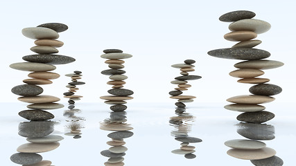 Image showing Stability and harmony. Pebble stacks on water