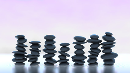 Image showing Harmony and balance. Many Pebble stacks on water