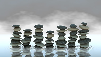 Image showing Group of Pebble stacks on water level