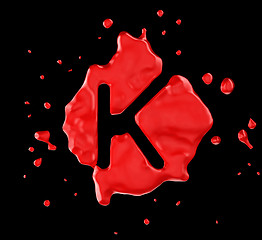 Image showing Red blot K letter over black background