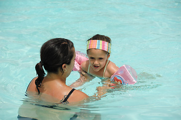 Image showing Child is learning to swim
