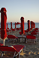 Image showing Red Sunshades And Sunbeds