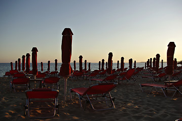 Image showing Red Sunshades And Sunbeds