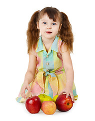 Image showing Emotional surprised girl with apples sit on white