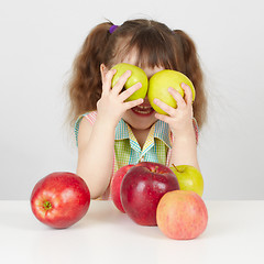 Image showing Funny child playing with two apples