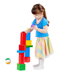 Image showing Girl build a tower of toy bricks