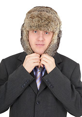 Image showing Man puts on head a fur hat