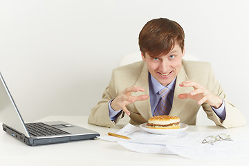 Image showing Young hungry man is going to eat a sandwich