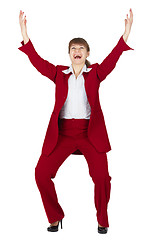 Image showing Jubilant young woman in red business suit