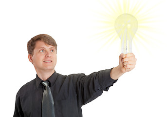 Image showing Young man lit by bright idea in form of electric light