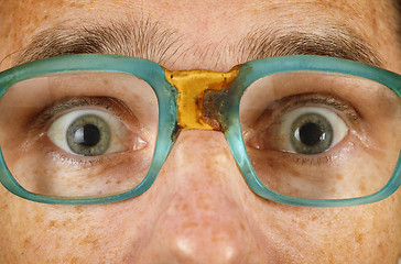 Image showing Eyes of surprised person in old spectacles