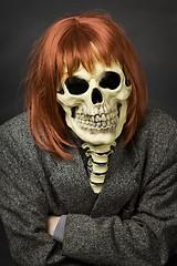 Image showing Person in mask of death and red wig