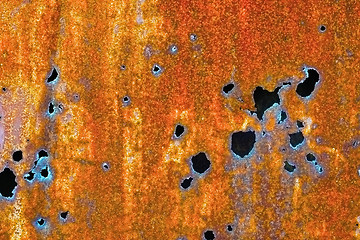 Image showing Old rusty sheet of iron with holes