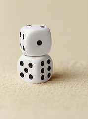 Image showing Two dice on yellow sand