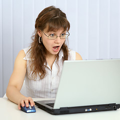 Image showing Angry woman browses websites