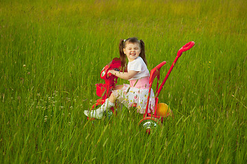 Image showing Comical child on a bicycle - grimace