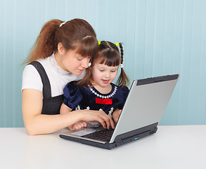 Image showing Mother teaches child to use laptop