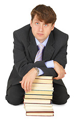 Image showing Young erudition man with stack of books