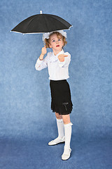 Image showing Girl with an umbrella under imaginary rain