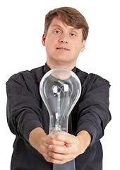 Image showing Young man with electric bulb in hands