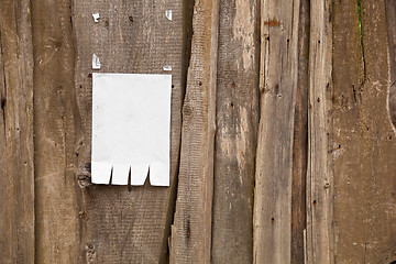 Image showing Paper ad on wooden fence