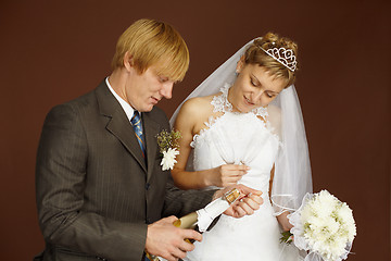 Image showing Couple opens a bottle of sparkling wine