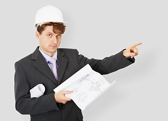 Image showing Young engineer - building specialist in helmet with drawing