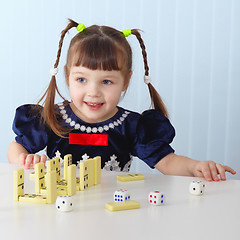 Image showing Smiling girl sitting at table