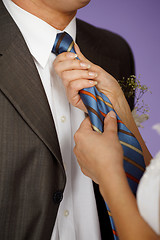 Image showing Woman straightens his tie