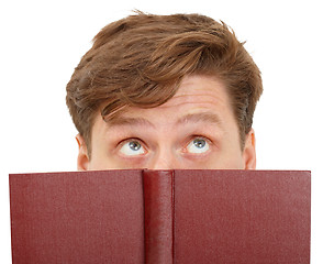 Image showing Man dreamily reading book - close-up of eyes