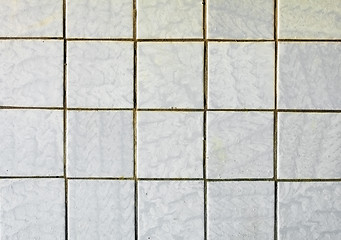 Image showing Old-fashioned gray tiles on old wall