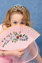 Image showing Girl coyly covered face with fan