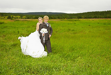 Image showing Bride and groom on nature in field