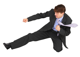 Image showing Businessman kicks forward on white background