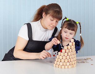 Image showing Mother and daughter building tower of bingo