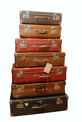 Image showing Pile of battered old suitcases