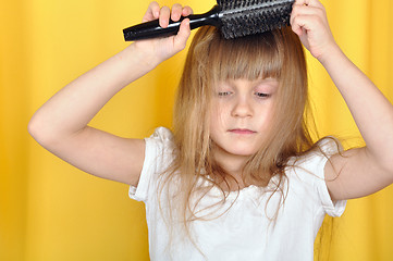 Image showing child brushing her hair