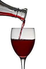 Image showing red wine pouring down from a wine decanter