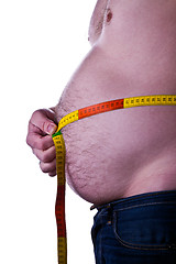 Image showing fat man holding a measurement tape 