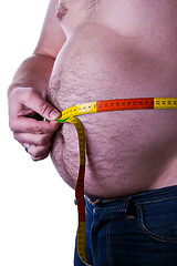 Image showing fat man holding a measurement tape 