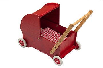 Image showing Red dolls pram with doll